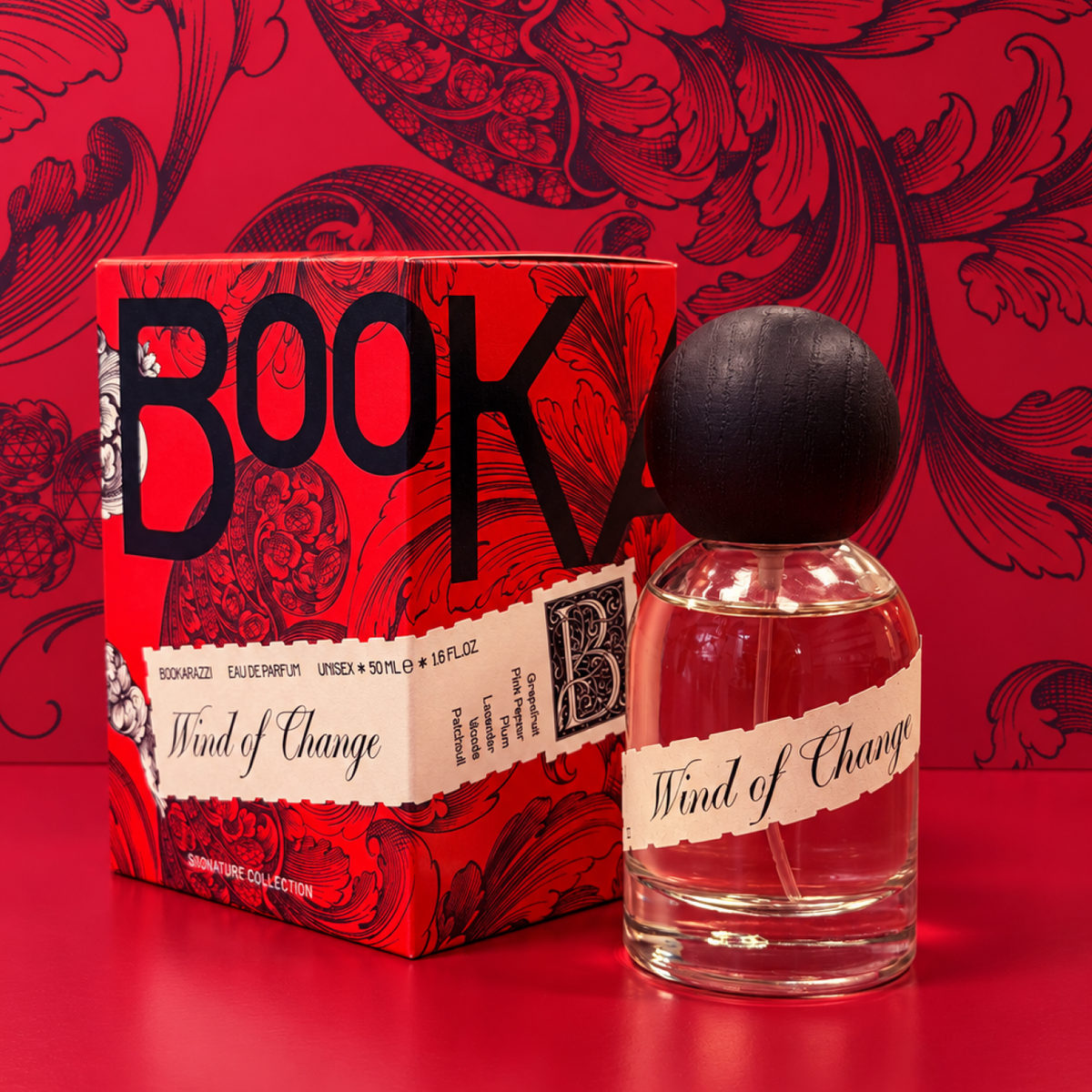 Parfum Wind of Change — fľaška vedľa darčekovej krabičky na červenom pozadí
